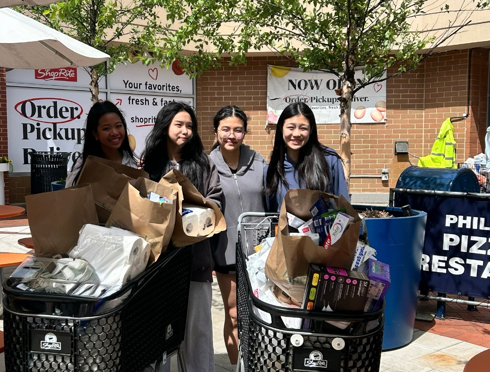 Volunteers with carts of donated hygiene and health supplies