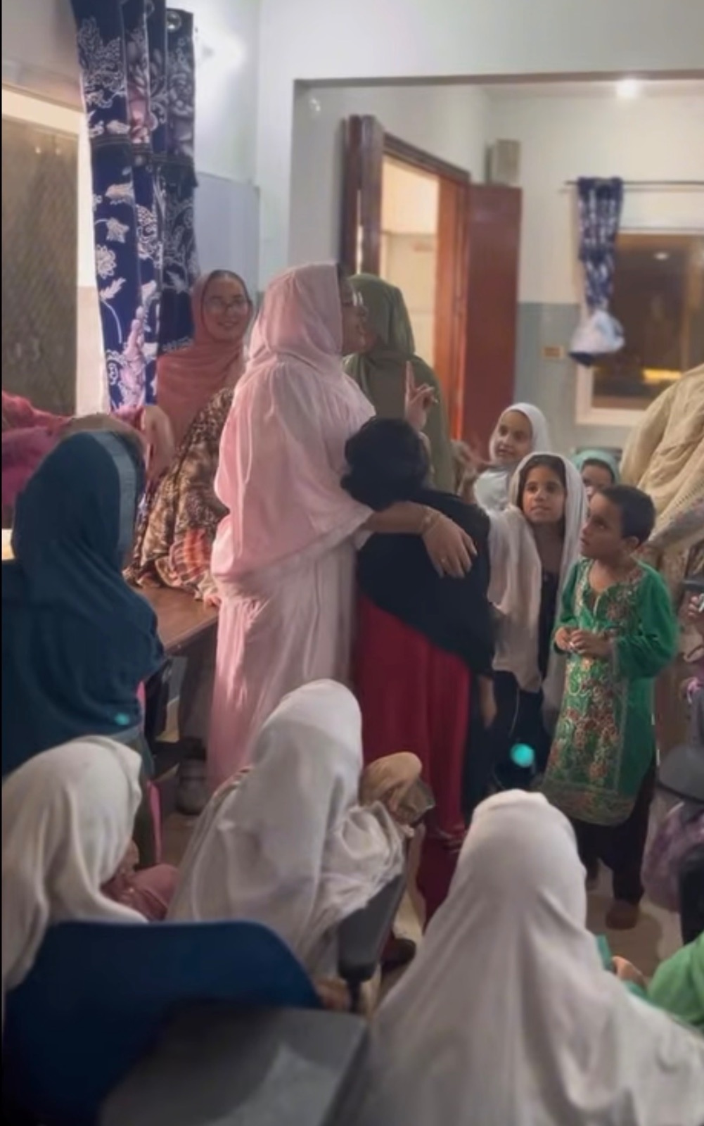 Paeonia volunteer embracing a child at the Karachi orphanage