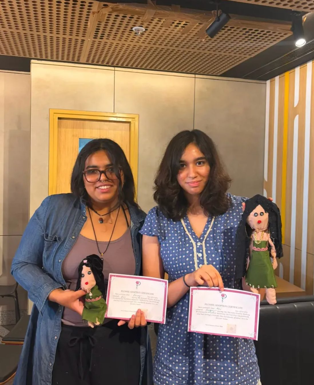 Jalandhar branch members holding handmade plushies and their adoption certificates