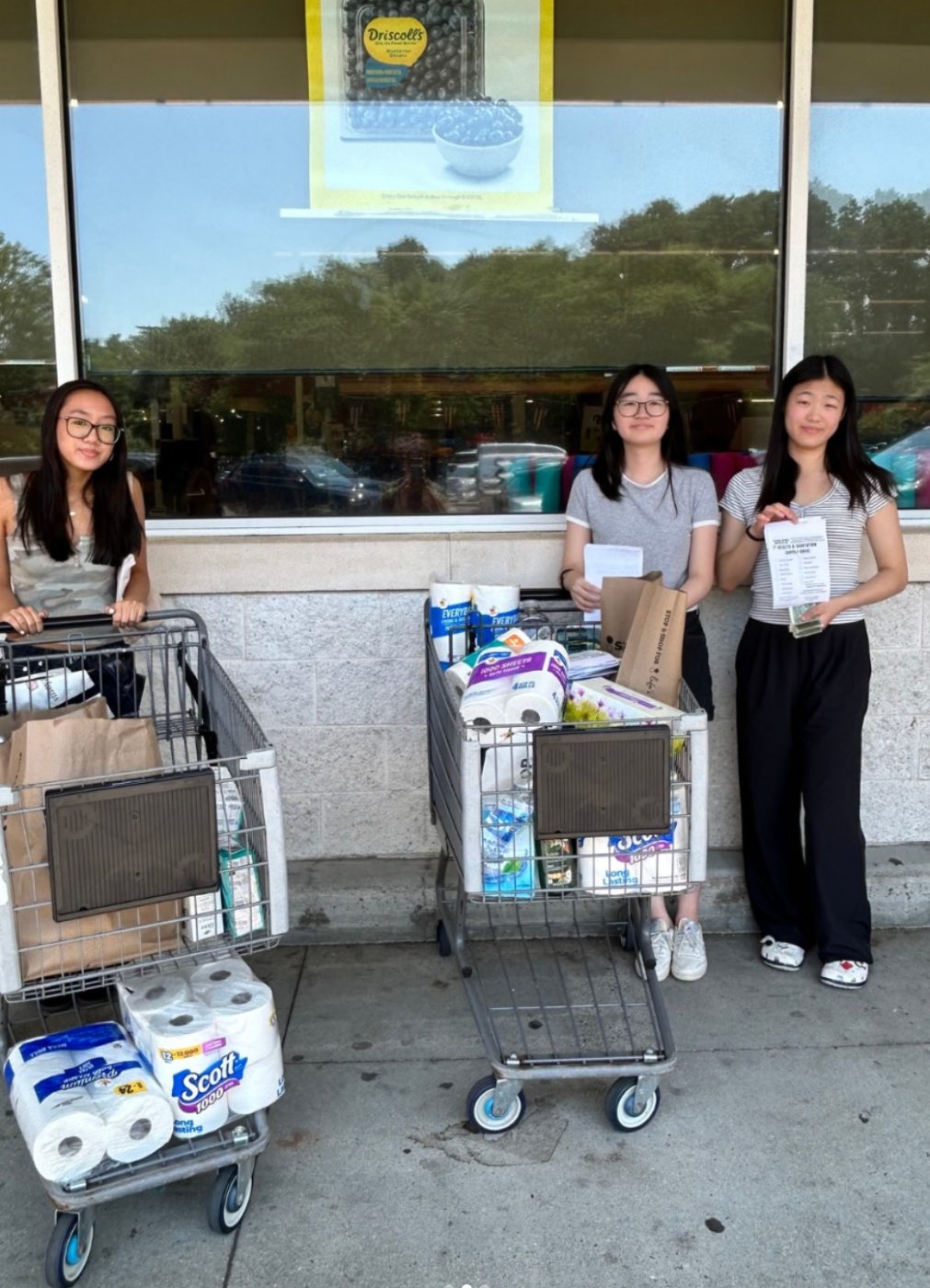 Parent branch members with carts full of donated hygiene and sanitation supplies outside Stop & Shop